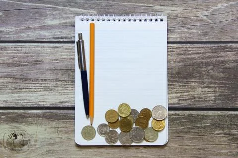 Notepad with a blank white sheet in a checker paper with russian coins and ba Stock Photos
