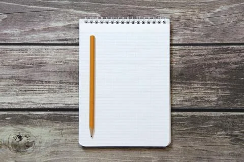 Notepad with a blank white sheet in a checker paper with simple graphite penc Stock Photos