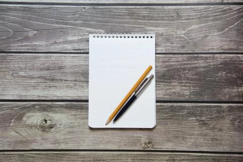 Notepad with a blank white sheet in a checker paper with ball pen and simple  Stock Photos
