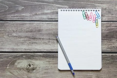 Notepad with a blank white sheet in a checker paper and with ball pen and wit Stock Photos
