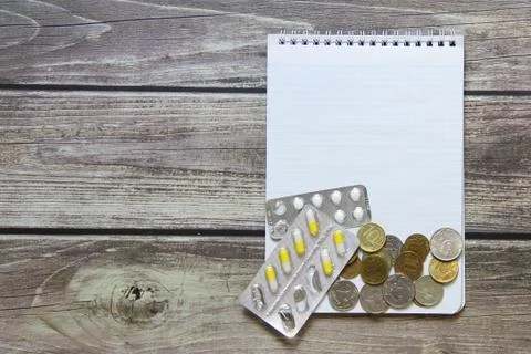 Notepad with a blank white sheet in a checker paper with russian coins and pi Stock Photos