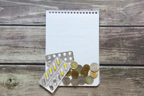 Notepad with a blank white sheet in a checker paper with russian coins and pi Stock Photos