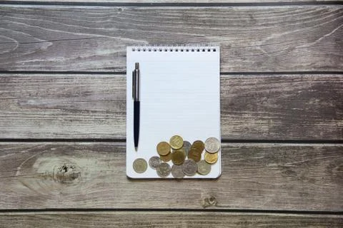 Notepad with a blank white sheet in a checker paper with russian coins and ba Stock Photos