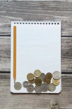 Notepad with a blank white sheet in a checker paper with russian coins and pe Stock Photos