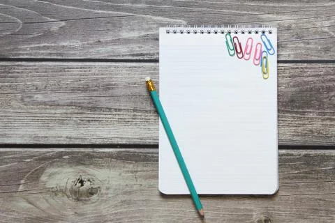 Notepad with a blank white sheet in a checker paper with simple graphite penc Stock Photos
