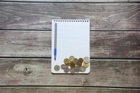 Notepad with a blank white sheet in a checker paper with russian coins and ba Stock Photos