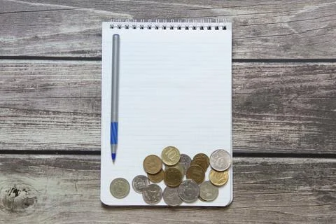 Notepad with a blank white sheet in a checker paper with russian coins and ba Stock Photos