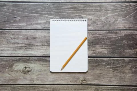 Notepad with a blank white sheet in a checker paper with simple graphite penc Stock Photos