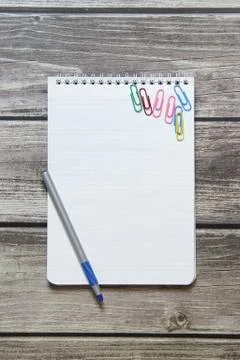 Notepad with a blank white sheet in a checker paper and with ball pen and wit Stock Photos