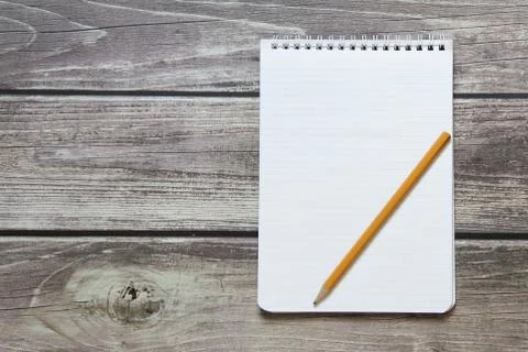 Notepad with a blank white sheet in a checker paper with simple graphite penc Stock Photos