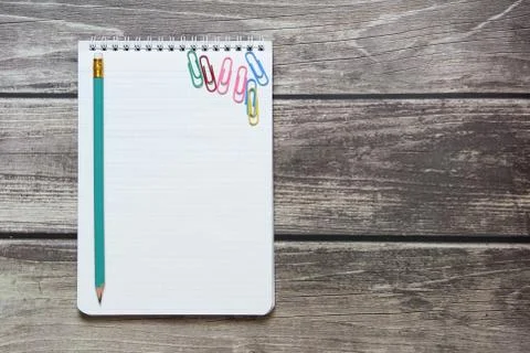 Notepad with a blank white sheet in a checker paper with simple graphite penc Stock Photos