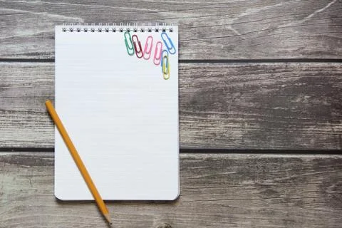 Notepad with a blank white sheet in a checker paper with simple graphite penc Stock Photos