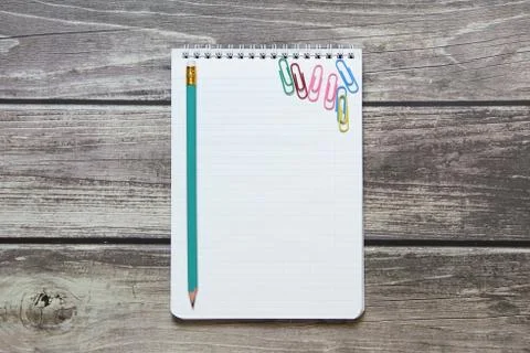 Notepad with a blank white sheet in a checker paper with simple graphite penc Stock Photos