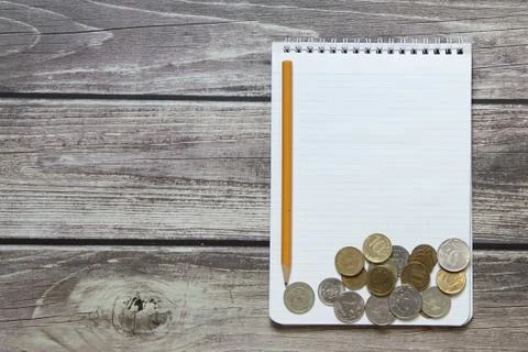 Notepad with a blank white sheet in a checker paper with russian coins and pe Stock Photos