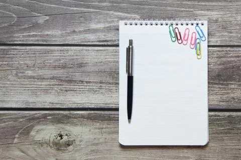 Notepad with a blank white sheet in a checker paper and with ball pen and wit Stock Photos