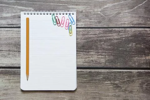 Notepad with a blank white sheet in a checker paper with simple graphite penc Stock Photos