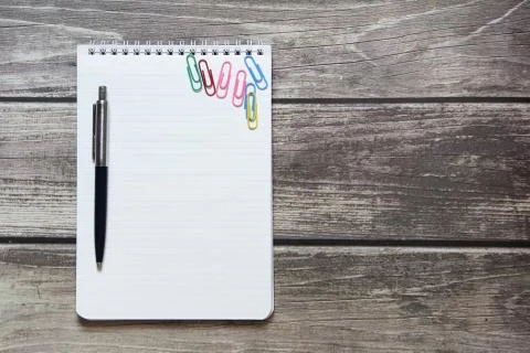 Notepad with a blank white sheet in a checker paper and with ball pen and wit Stock Photos