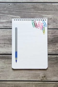 Notepad with a blank white sheet in a checker paper and with ball pen and wit Stock Photos