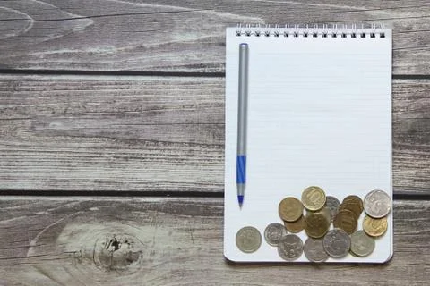 Notepad with a blank white sheet in a checker paper with russian coins and ba Stock Photos