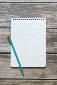 Notepad with a blank white sheet in a checker paper with simple graphite penc Stock Photos