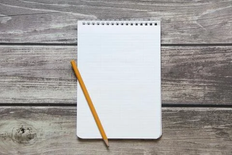 Notepad with a blank white sheet in a checker paper with simple graphite penc Stock Photos