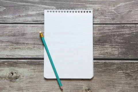 Notepad with a blank white sheet in a checker paper with simple graphite penc Stock Photos