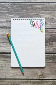 Notepad with a blank white sheet in a checker paper with simple graphite penc Stock Photos