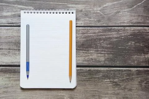 Notepad with a blank white sheet in a checker paper with ball pen and simple  Stock Photos