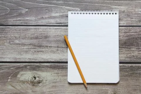 Notepad with a blank white sheet in a checker paper with simple graphite penc Stock Photos
