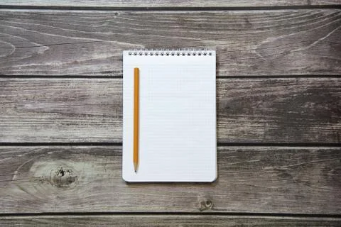 Notepad with a blank white sheet in a checker paper with simple graphite penc Stock Photos