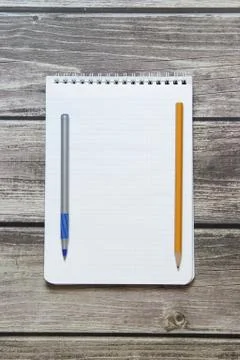 Notepad with a blank white sheet in a checker paper with ball pen and simple  Stock Photos