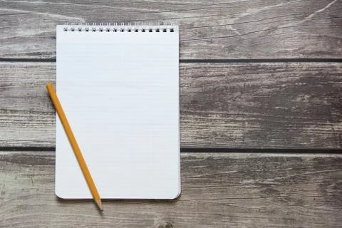 Notepad with a blank white sheet in a checker paper with simple graphite penc Stock Photos