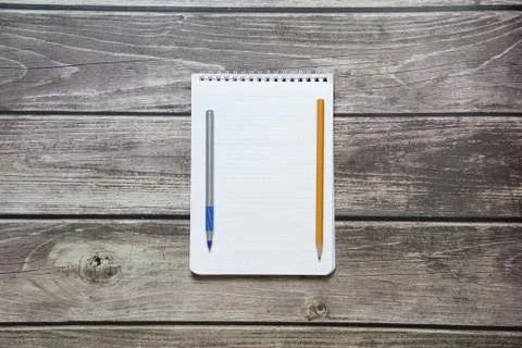 Notepad with a blank white sheet in a checker paper with ball pen and simple  Stock Photos
