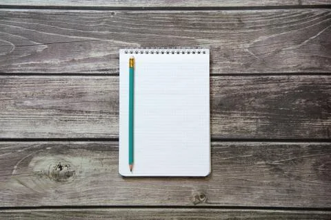 Notepad with a blank white sheet in a checker paper with simple graphite penc Stock Photos