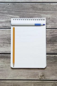 Notepad with a blank white sheet in a checker paper with ball pen and simple  Stock Photos