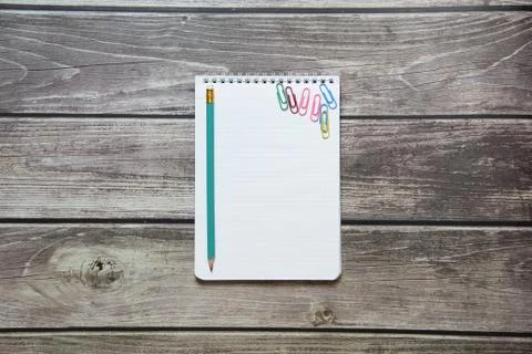 Notepad with a blank white sheet in a checker paper with simple graphite penc Stock Photos