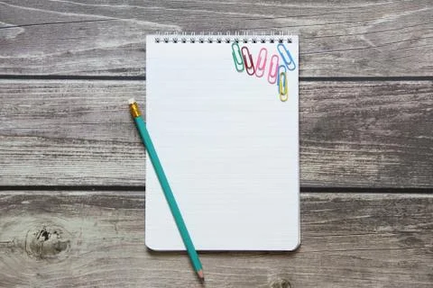 Notepad with a blank white sheet in a checker paper with simple graphite penc Stock Photos