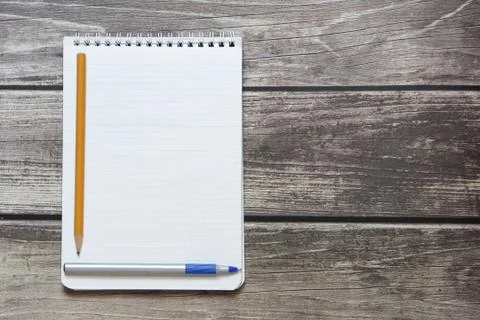 Notepad with a blank white sheet in a checker paper with ball pen and simple Stock Photos