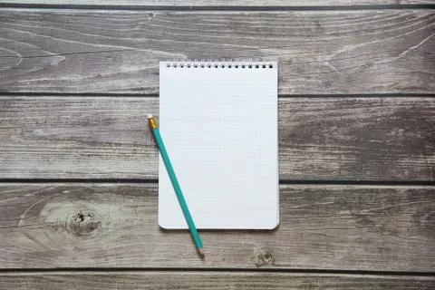Notepad with a blank white sheet in a checker paper with simple graphite penc Stock Photos