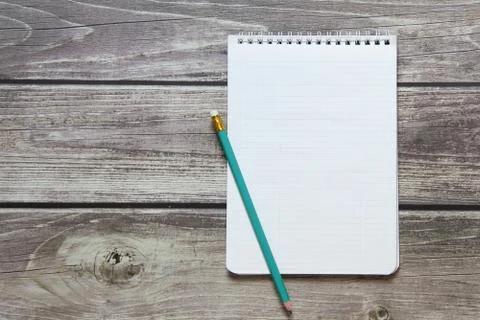 Notepad with a blank white sheet in a checker paper with simple graphite pencil Stock Photos