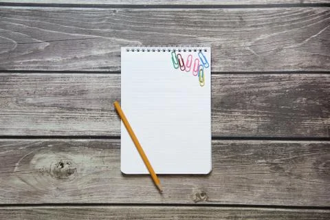 Notepad with a blank white sheet in a checker paper with simple graphite pencil Stock Photos