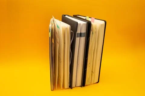 Notepad on a bright yellow background, sheets of paper, words on paper Stock Photos