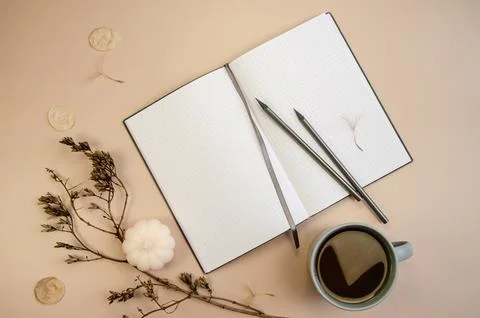 Notepad copyspace, gray pencils and cup of coffee  on tan begie background Stock Photos