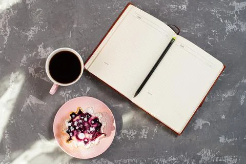 Notepad, a cup of coffee and a cake basket with berries and cottage cheese on Stock Photos