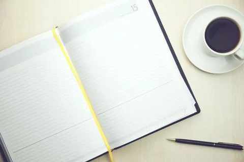 Notepad with cup of coffee Stock Photos