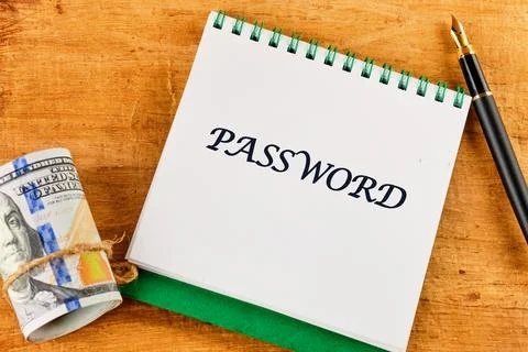 A notepad displaying the word password alongside a rolled banknote and a pen  Stock Photos