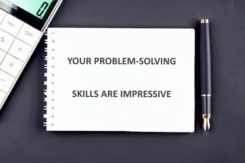 A notepad displays an encouraging message about problem-solving skills, posit Stockfoto's