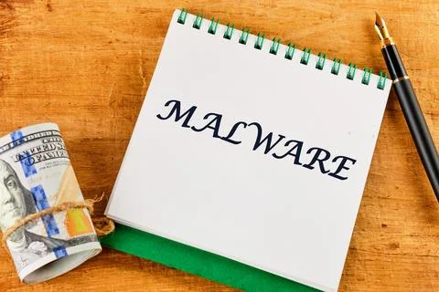 A notepad displays the word malware, highlighting a significant cybersecuri.. Stock Photos