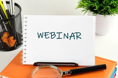 A notepad displays the word webinar in an organized workspace that includes a Stock Photos