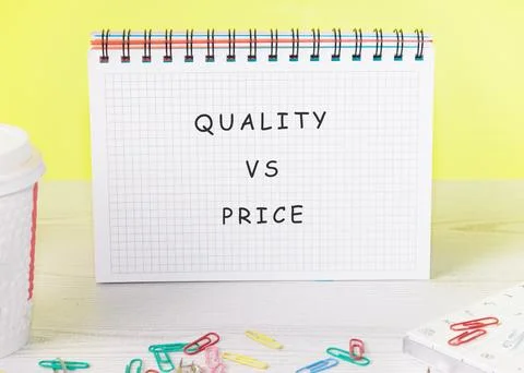A notepad displays the words quality and price during a discussion at a works Stock Photos
